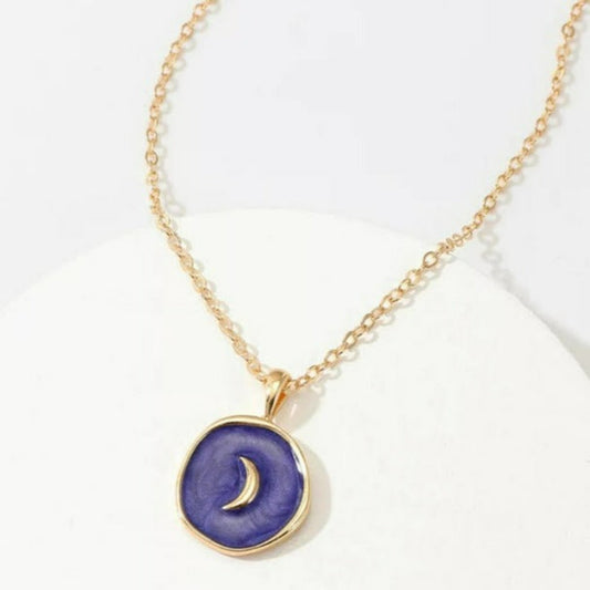 Gold necklace with a coin pendant filled in blue enamel and a gold half moon in the center