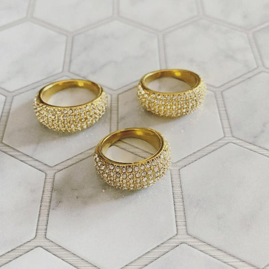 High-end, gold plated, stainless steel ring with a bed of encrusted Pave, diamond like crystals all around. Makes and affordable wedding band for him or her, available in sizes 6,7,8